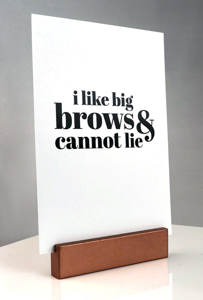 Sign stand with print inserted. I Like Big Brows & Cannot Lie