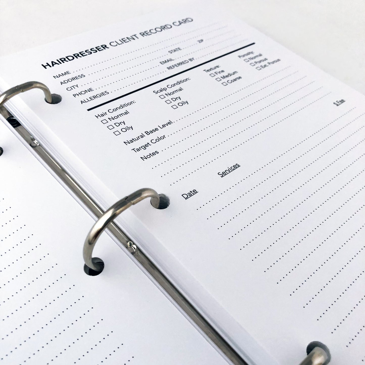 Hairdresser client record card in binder