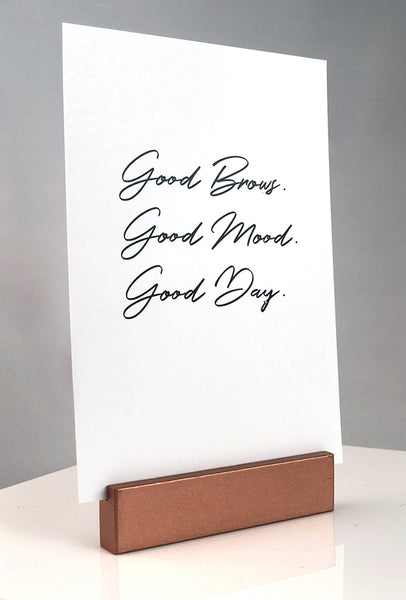 Sign stand with print inserted. Good Brows. Good Mood. Good Day.
