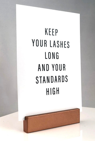 Sign stand with print inserted. Keep your lashes long and your standards high