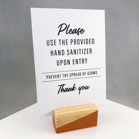 Wooden block sign holder hand painted with angled orange design holding a small sign